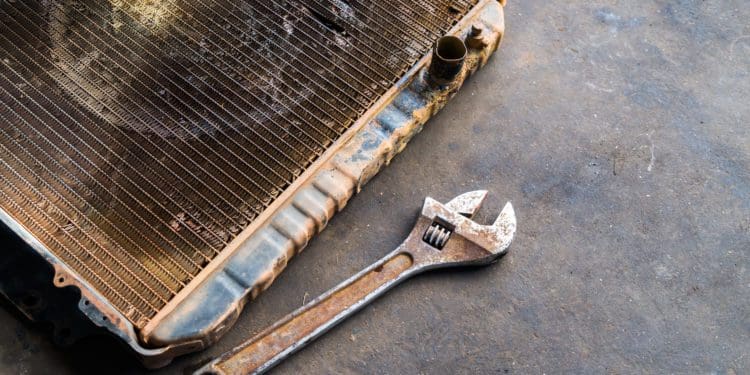 Old radiator with wrench, repair